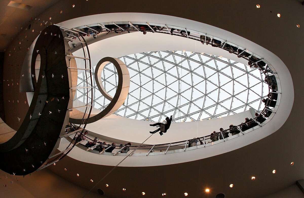 Eric Williams, with Bay Area Window Cleaning, decked out in Dali looking attire, rappels 75 feet from the top of the glass enigma down past the Helical Staircase, a spiral that ascends to the third floor galleries and beyond, down into the floor of the Cafe Gala during the one-year anniversary celebration of the Salvador Dal� Museum in St. Petersburg, Fla. Wednesday, Jan. 11, 2012. The museum logged 370,000 ticketed visitors its first year, double the attendance the year before in the Dal�'s former location. (AP Photo/Tampa Bay Times, Dirk Shadd) TAMPA OUT; CITRUS COUNTY OUT; PORT CHARLOTTE OUT; BROOKSVILLE HERNANDO TODAY OUT