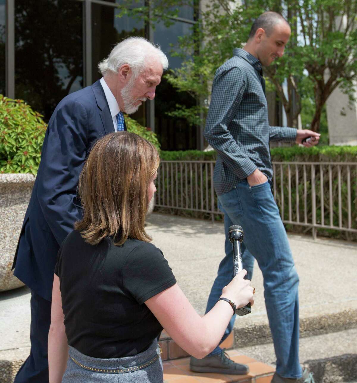 Spurs coach Gregg Popovich, left, and player Manu Ginobili skirt around reporters as they leave the federal courthouse in San Antonio Tuesday, June 27, 2017 after attending a sentencing hearing in Tim Duncan's legal case against Duncan's former financial adviser Charles Banks.