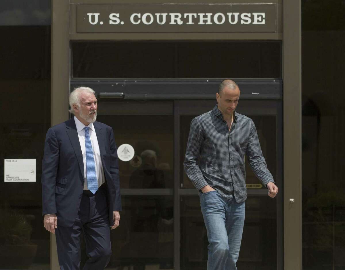 Spurs coach Gregg Popovich, and player Manu Ginobili leave the federal courthouse in after attending a sentencing hearing in Tim Duncan's legal case against former financial adviser Charles Banks.