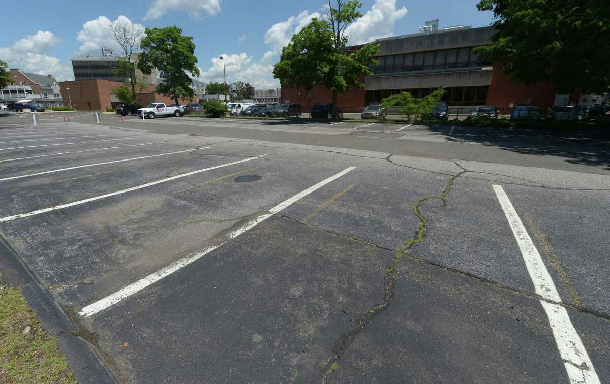 The parking lot that serves 11 Belden Ave. exclusively which is also adjacent to the Norwalk Public library main branch Thursday, June 1, 2017, in Norwalk, Conn. Alex Knopp, president of the library board, announced late Wednesday night that a deal had been struck with developer Jason Milligan to provide additional parking to library patrons at the adjacent lot on Mott Avenue.