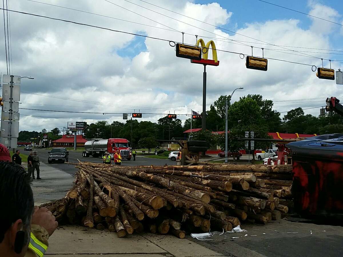 Lumber is in the road at Business 96 and FM 327 in Silsbee after a logging truck overturned Wednesday, June 28, 2017.