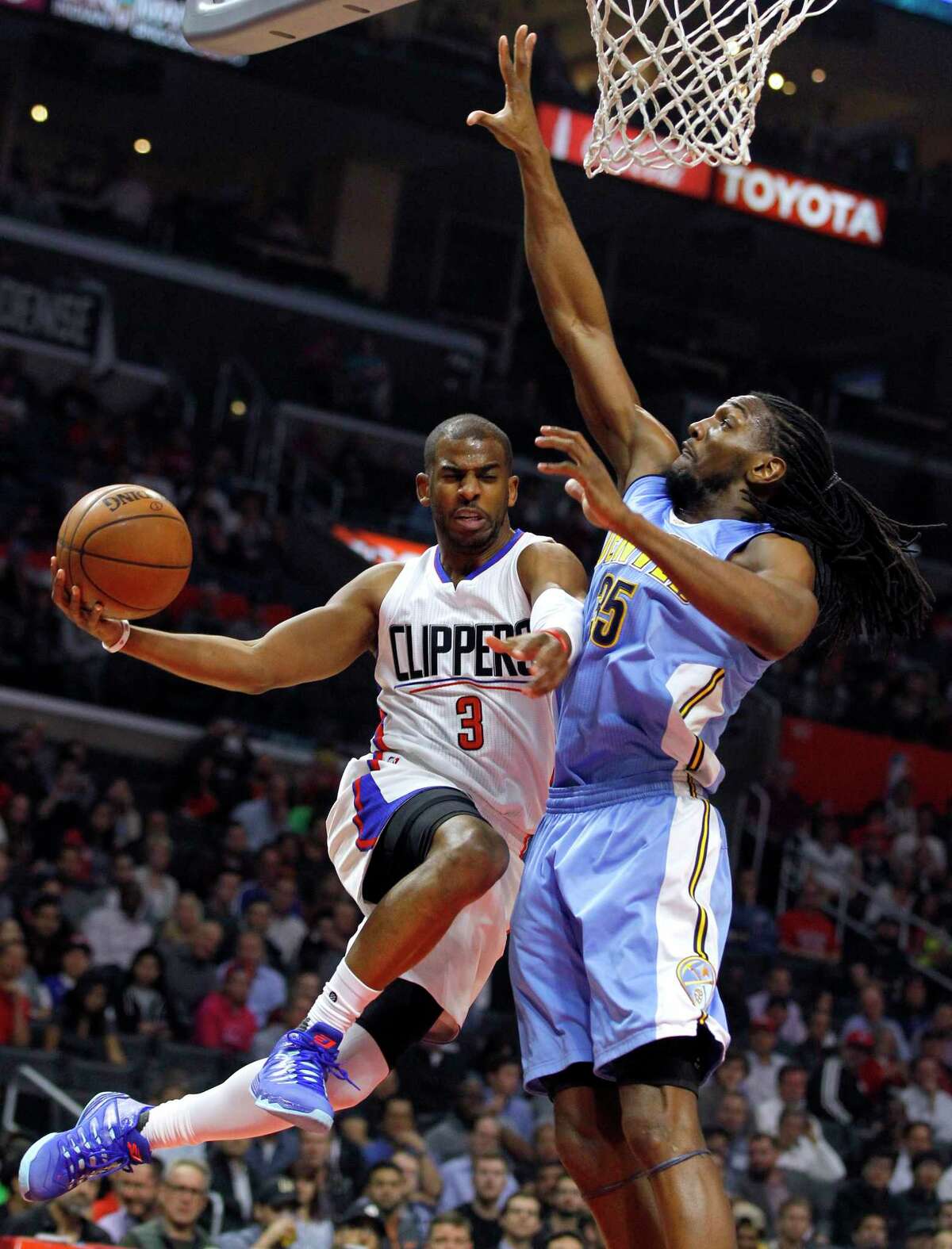 FILE - In this Feb. 24, 2016, file photo, Los Angeles Clippers guard Chris Paul (3) goes up under the basket, next to Denver Nuggets forward Kenneth Faried (35) during the first half of an NBA basketball game in Los Angeles. The Houston Rockets have reached an agreement to trade for Los Angeles Clippers point guard Chris Paul according to a person familiar with the deal. The league source spoke to The Associated Press on Wednesday, June 28, 2017, on the condition of anonymity because the team hasn't finalized the trade. (AP Photo/Alex Gallardo, File)