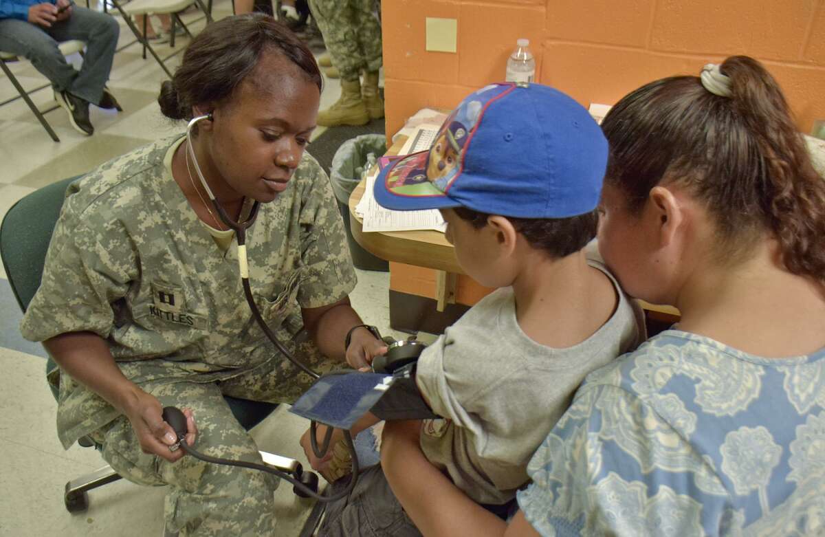Captain Delilah Kittles check Oscar Martinez blood pressure as part of the Operations Health and Wellness in collaboration with Texas A& Colonias Program, U.S. Army Reserve, and Webb County Wednesday June 21 2017 at the Larga Vista Community Center.