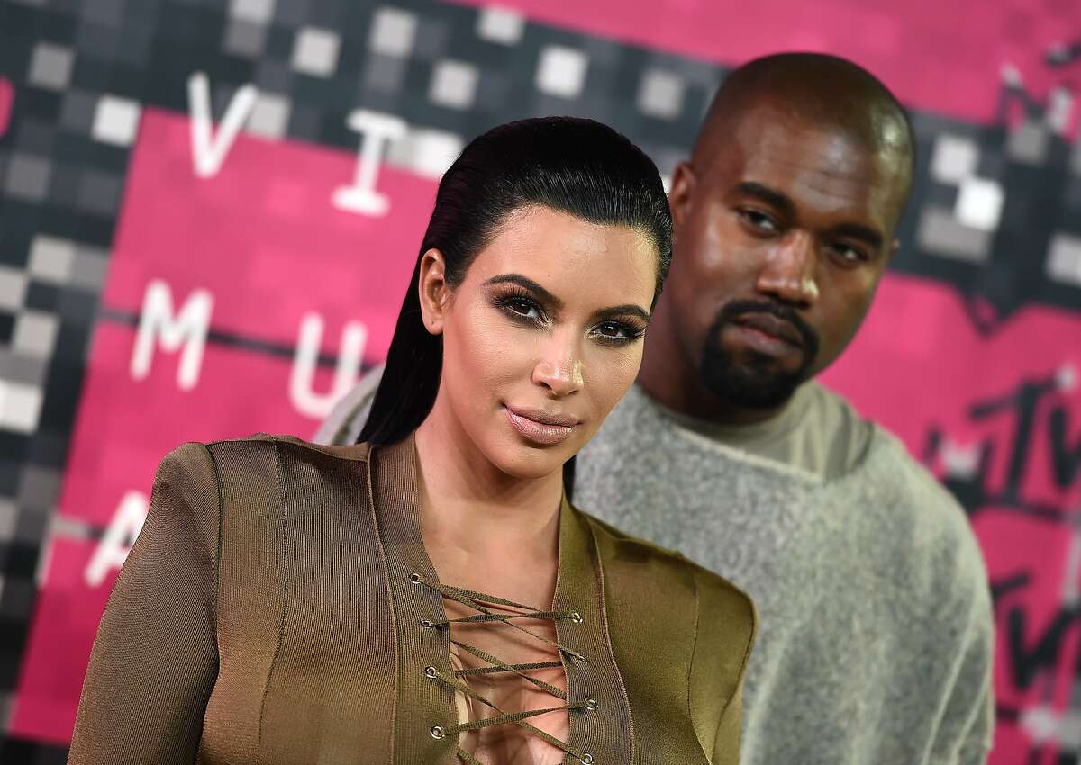 FILE - In this Aug. 30, 2015, file photo, Kim Kardashian, left, and Kanye West arrive at the MTV Video Music Awards at the Microsoft Theater in Los Angeles. Kardashian praised her husband's May 19, 2016, appearance on "The Ellen DeGeneres Show" on Twitter. (Photo by Jordan Strauss/Invision/AP, File)