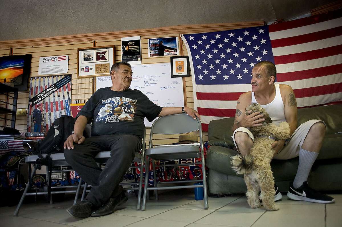 Deported U.S. military veterans Andy de Leon, left, and Alejandro Gomez Cortez chat at the Deported Veterans Support House in Tijuana.