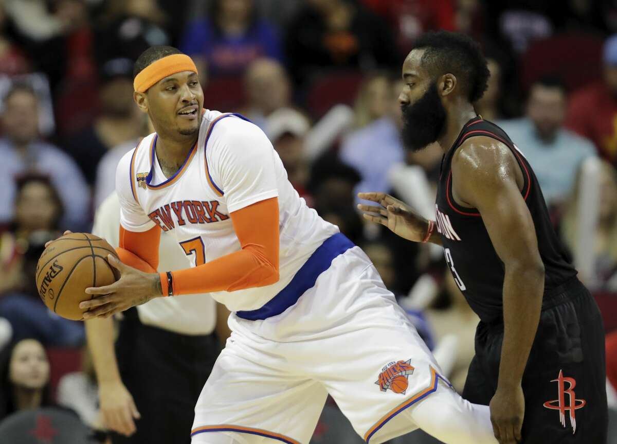 HOUSTON, TX - DECEMBER 31: Carmelo Anthony #7 of the New York Knicks controls the ball defended by James Harden #13 of the Houston Rockets in the first half at Toyota Center on December 31, 2016 in Houston, Texas. NOTE TO USER: User expressly acknowledges and agrees that, by downloading and or using this photograph, User is consenting to the terms and conditions of the Getty Images License Agreement. (Photo by Tim Warner/Getty Images)