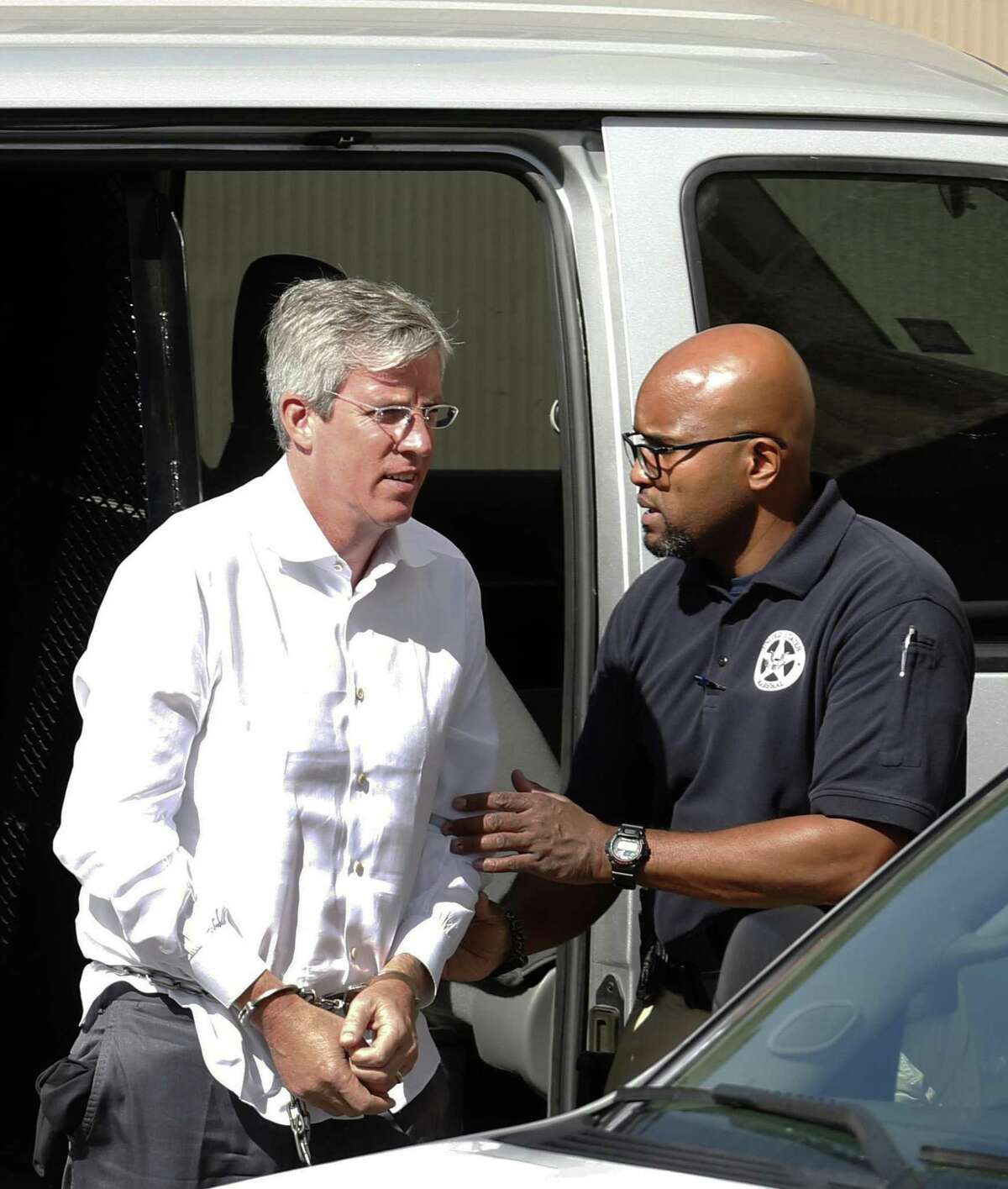 Tim Duncan's former financial adviser, Charles Banks, is transported to federal court early Friday morning after he turned himself in on federal charges. Banks was apparently indicted this week in connection with allegations that he duped Duncan into making certain investments, losing between $1.1 million and $25 million of Duncan's money. Photos taken on Friday, September 9, 2016.