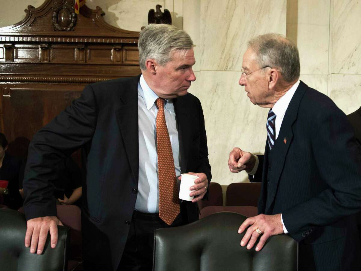 FILE - In this Jan. 11, 2017 file photo, Sen. Sheldon Whitehouse, D-R.I., left, confers with Sen. Charles Grassley, R-Iowa on Capitol Hill in Washington. Bipartisan legislation to limit the influence of so-called shell corporations in the U.S. could get a boost as Congress probes the ways that Russia influenced last year's election. (AP Photo/Cliff Owen, File)