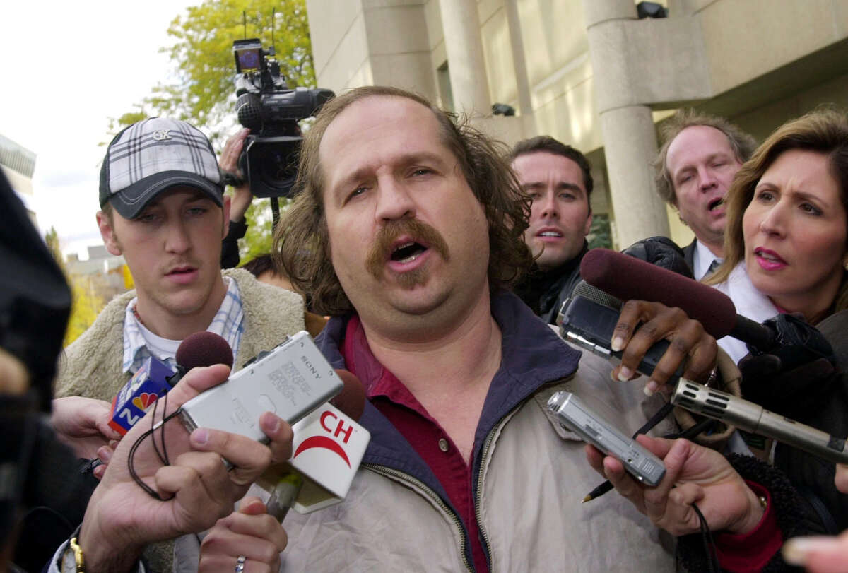 FILE - In this Thursday, Oct. 23, 2003, file photo, Kirk Jones of Canton, Mich., the man who survived a plunge over Niagara Falls, talks to reporters after being released from custody in St. Catherines, Ontario. Jones, who died after plunging over Niagara Falls in an apparent stunt with an inflatable ball might have brought a boa constrictor along for the ride, the Niagara Gazette reported Wednesday, June 28, 2017, that police found a website with a photo of Jones and the snake previewing Jones' plans. An unoccupied large plastic ball he apparently planned to ride over the falls was found empty below the falls in April. (AP Photo/David Duprey, File)