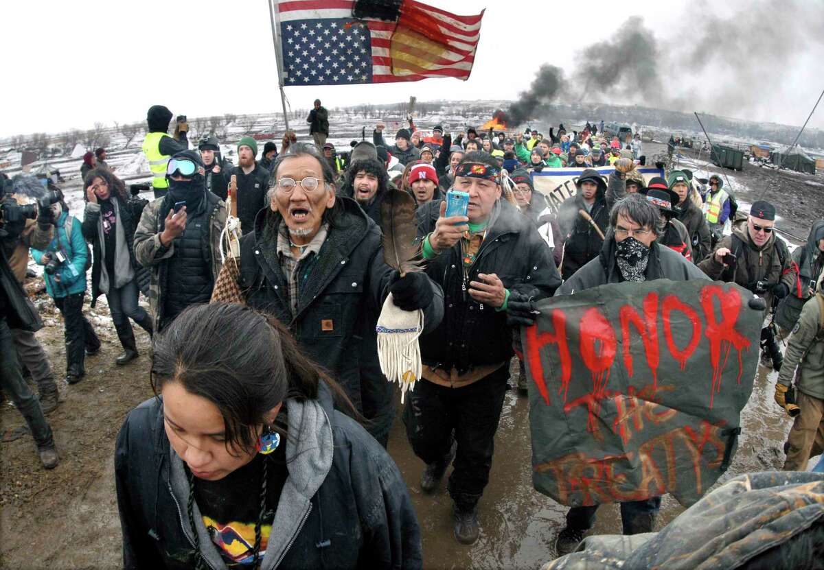 ﻿Dakota Access Pipeline protesters march out of their ﻿camp in February before the deadline set for evacuation ﻿by the U.S. Army Corps of Engineers. ﻿