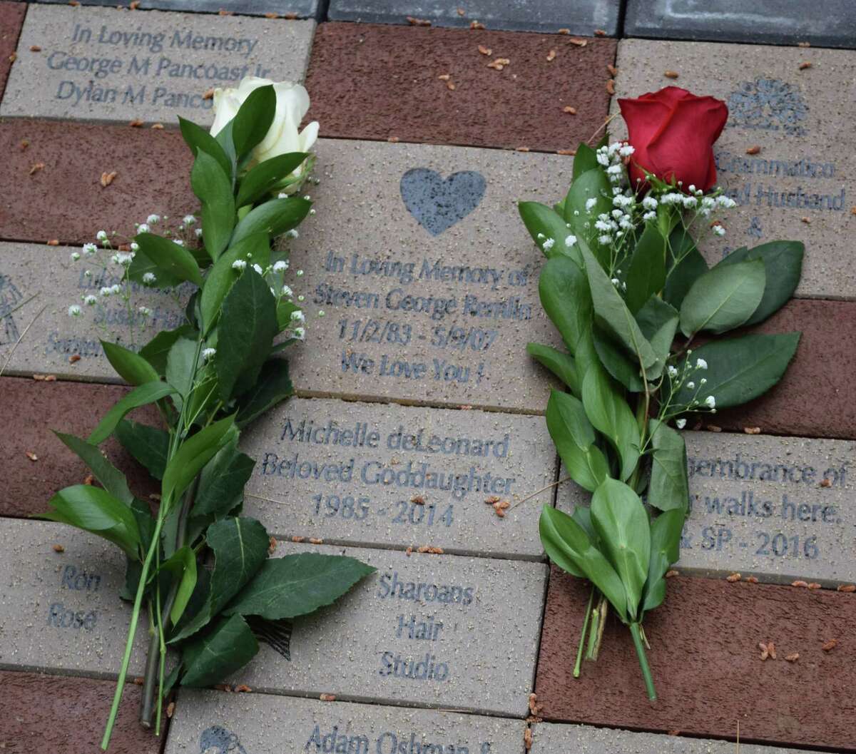 Roses convey a poignant message left by a guest at the dedication ceremony.