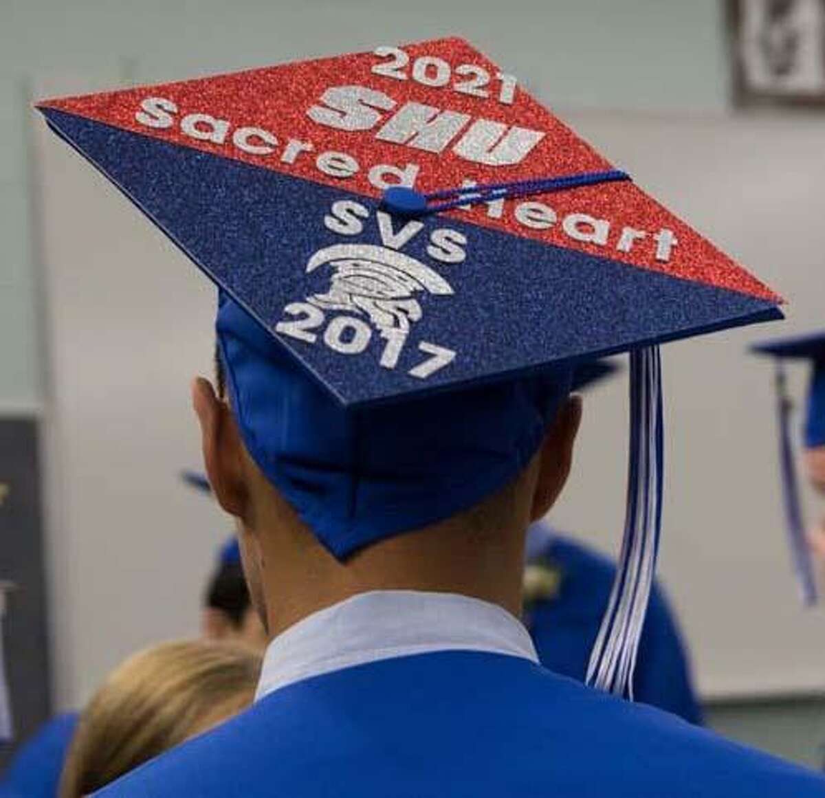A Shepaug Valley School graduate proudly showcases the name of his high school and the college he will attend at Shepaug’s graduation held June 17.