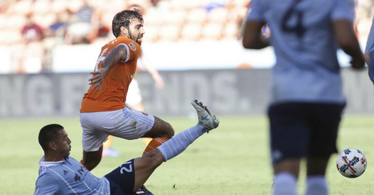 Sporting Kansas City midfielder Roger Espinoza (27) tries to tackle Houston Dynamo defender Kevin Garcia (16) during the first half of the Lamar Hunt U.S. Open Cut Round of 16 game at BBVA Compass Stadium Wednesday, June 28, 2017, in Houston. ( Yi-Chin Lee / Houston Chronicle )