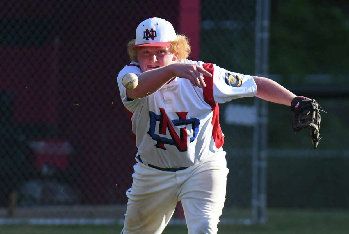 Harry Rayhill (54) of the Darien American Legion under hands the ball to first base during a game against the Greenwich Cannons at Greenwich High School on June 14, 2017 in Greenwich, Connecticut.