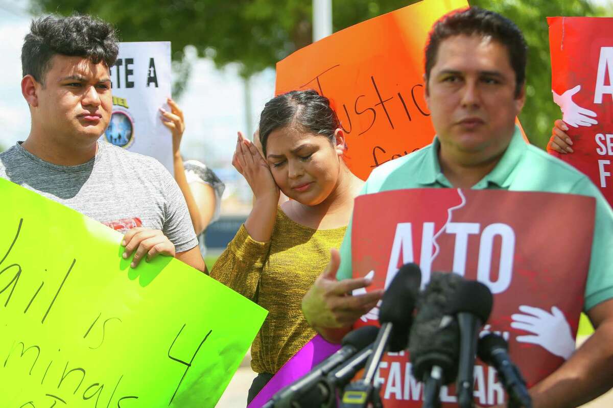 Alejandro Garcia talks about his wife, Lucia Montes, who was detained by Deer Park police during a Monday traffic stop, while his daughter, Alejandra, cries during a news conference outside the Deer Park police department on Wednesday.