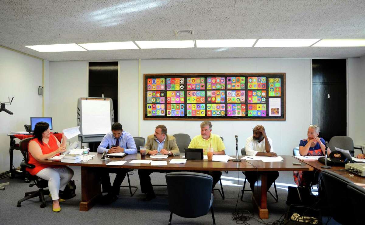 Bridgeport School Board member Maria Pereira, left, argues a point about a budget modification with Chairperson Joe Larcheveque, seated at center, during special meeting at Bridgeport City Hall building in Bridgeport, Conn., on Wednesday June 28, 2017. The board held the special meeting to decide if they will strike a deal with the city to allow the lighthouse summer program into city schools this summer.