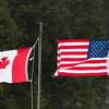 Canadian and American flags are seen at the US/Canada border March 1, 2017, in Pittsburg, New Hampshire.