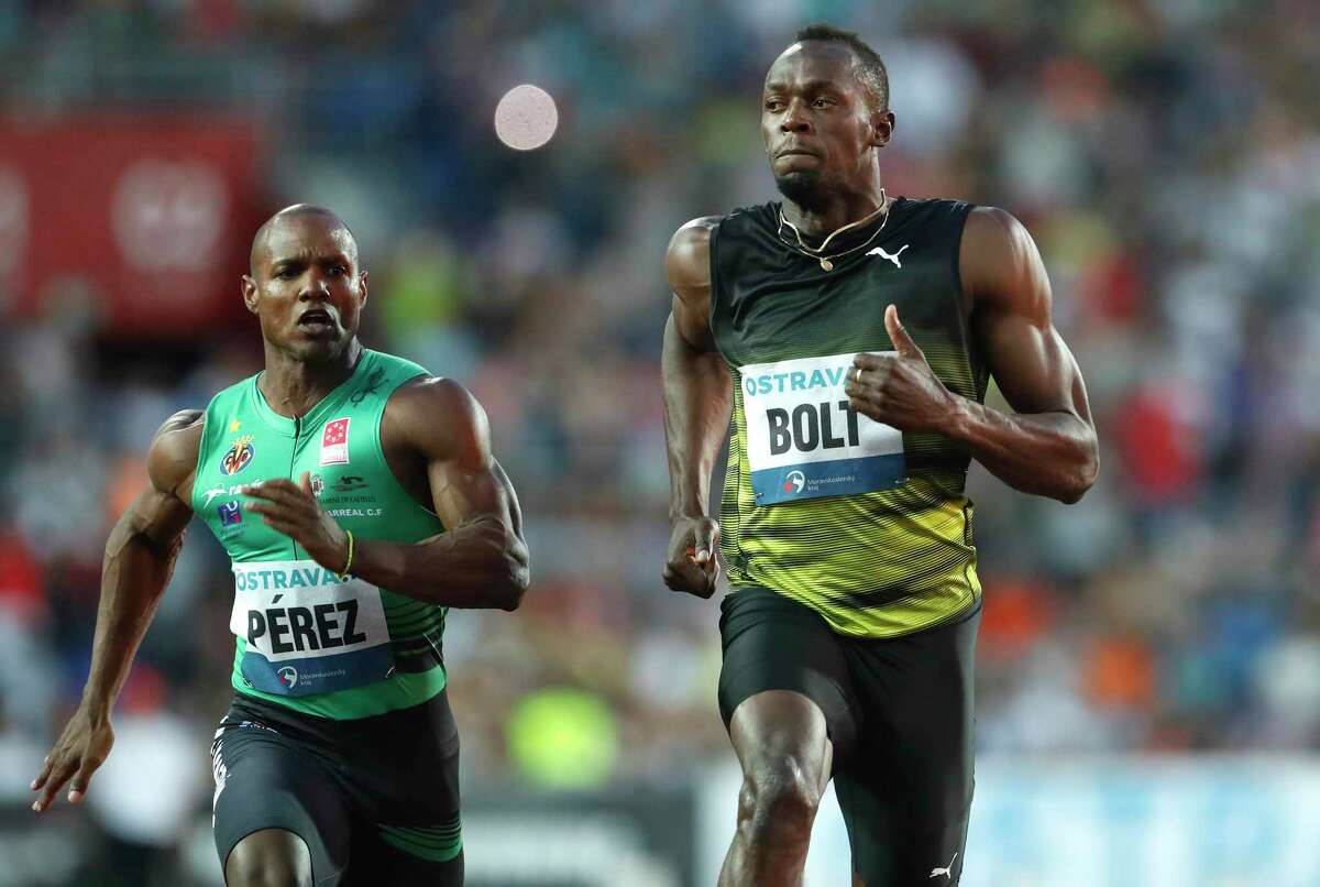 Usain Bolt, right, beats Cuba's Yunier Perez by three-hundredths of a second (10.06 to 10.09) to win the 100 meters at the Golden Spike meet. "I'm not happy with the time," Bolt said of one of his tune-ups before taking part in the world championships in August for the final meet of his career.