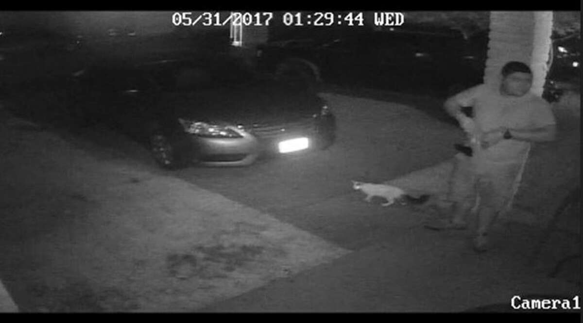 This image taken from surveillance footage shows the armed man that allegedly threatened to kill a family.  