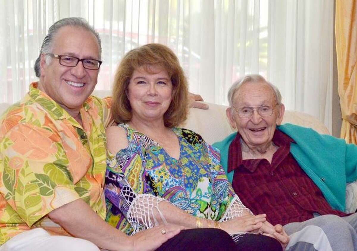 Stanley Keilson poses for a photo with Joe and Teena Arciniega at an intimate tea party held on Wednesday.  