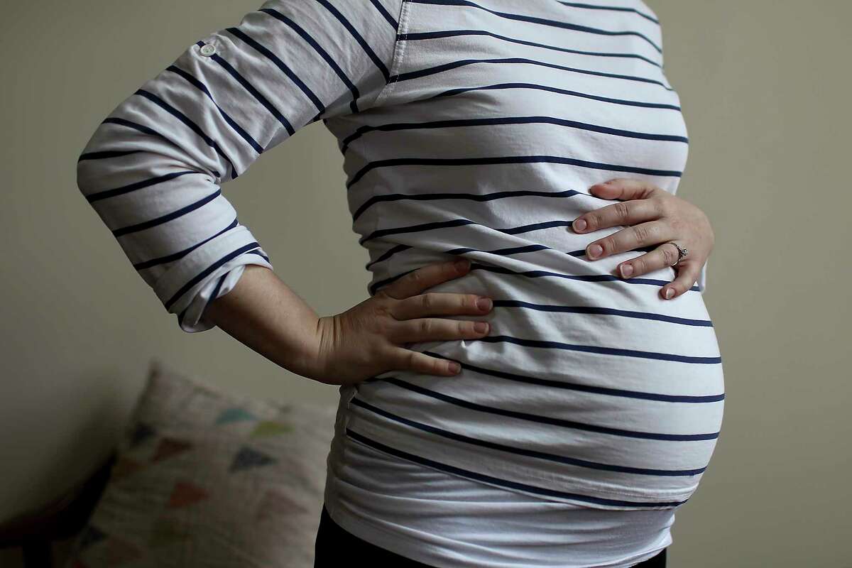 FILE — A pregnant woman, in her home in Laconia, N.H., March 14, 2013. Researchers found pregnancy alters the size and structure of a woman’s brain, mainly in areas involved in perceiving the feelings and perceptions of others. (Cheryl Senter/The New York Times)