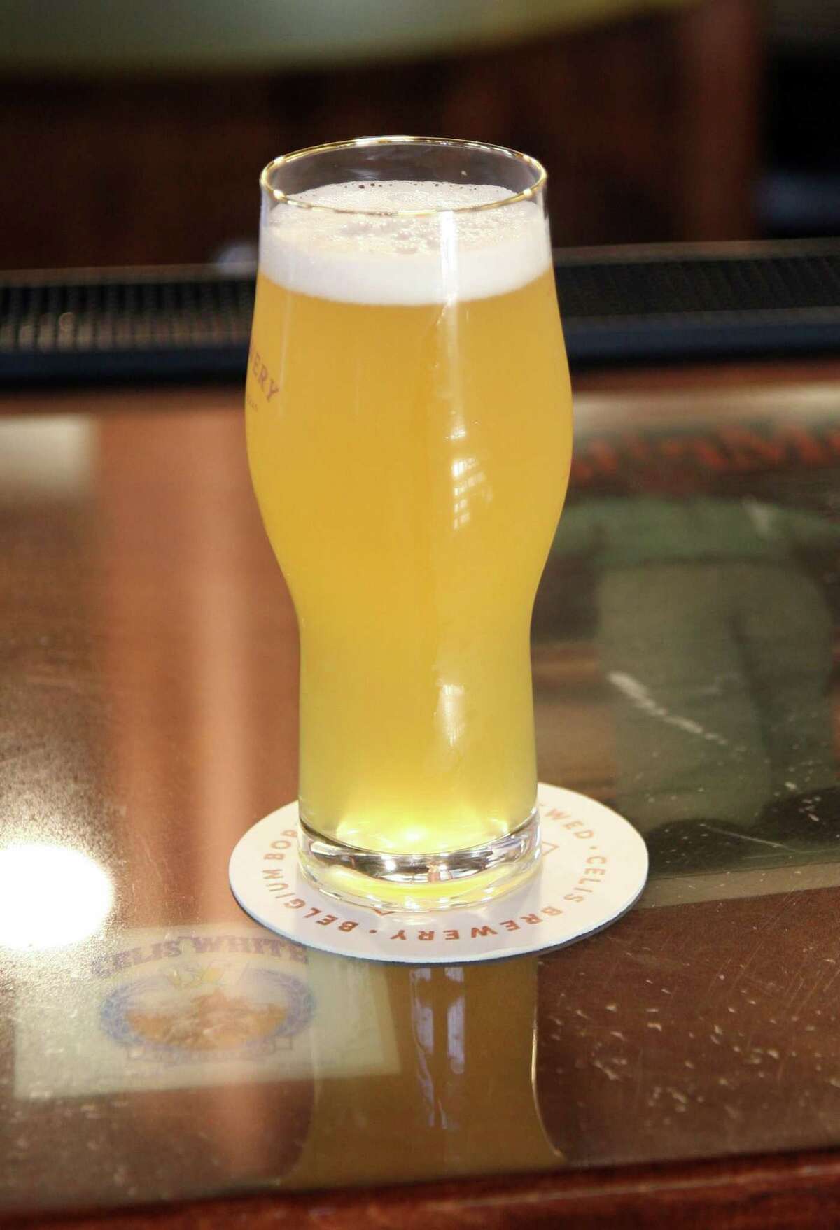 Celis White, a classic Belgian-style witbier, displays its classic straw color, haziness, and thick, bright head.