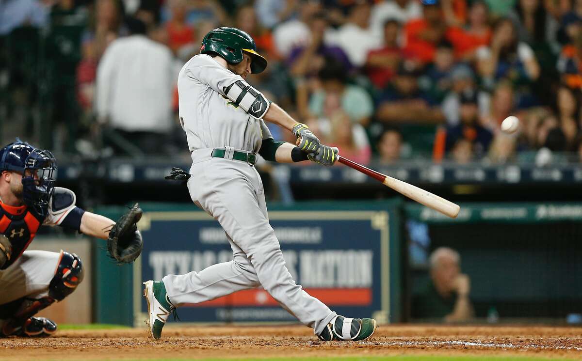 HOUSTON, TX - JUNE 28: Jed Lowrie #8 of the Oakland Athletics hits a home run in the seventh inning against the Houston Astros at Minute Maid Park on June 28, 2017 in Houston, Texas. (Photo by Bob Levey/Getty Images)