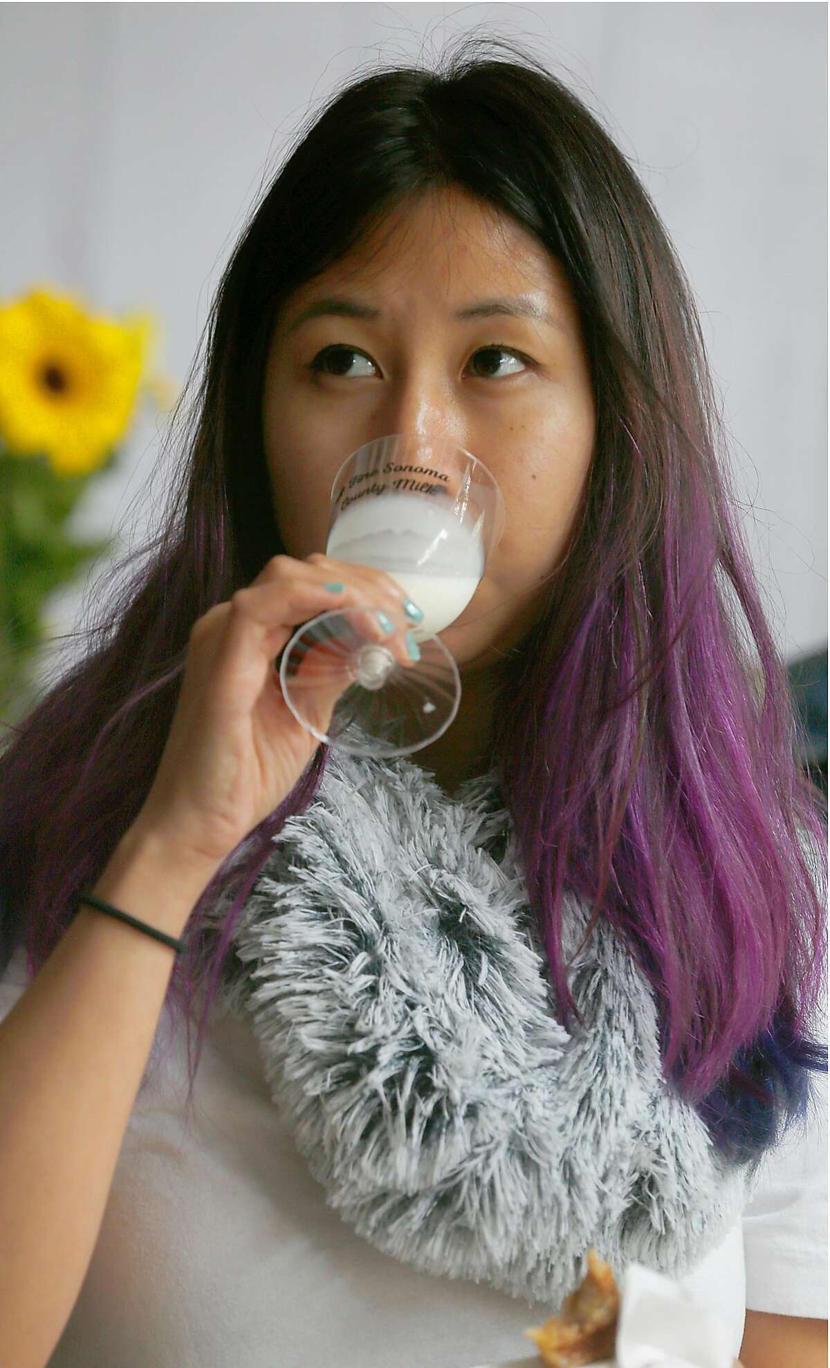 Elizabeth Tseng from San Francisco compares Clover 2% and whole milk as she listens to world�s first milk somoo'lier, Bas de Groot, holding a milk tasting session via Skype at the Clover Milk Tasting Room pop-up in Hayes Valley on Wednesday, June 28, 2017, in San Francisco, Calif.