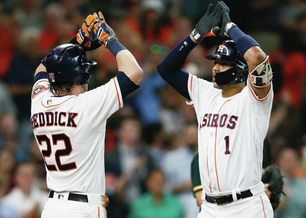 HOUSTON, TX - JUNE 29: Carlos Correa #1 of the Houston Astros receives high fives from Josh Reddick #22 after hitting a two-run home run in the fourth inning against the Oakland Athletics at Minute Maid Park on June 29, 2017 in Houston, Texas. (Photo by Bob Levey/Getty Images)