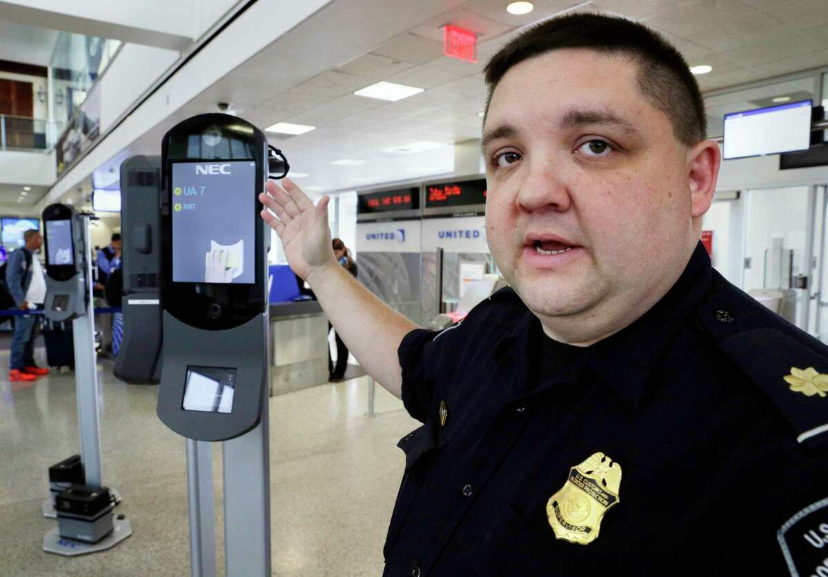 Ian Ramirez, a supervisor with U.S. Customs and Border Protection, explains the workings of the new face recognition kiosks at United Airlines gate E7 for a flight to Tokyo at Bush Intercontinental Airport in Houston, TX, June 29, 2017. (Michael Wyke / For the Chronicle)