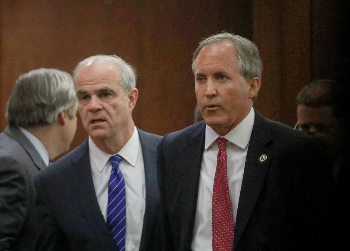 Texas Attorney General Ken Paxton, right, and his attorney Philip Hilder, left, leave the 177th District Court, after at the Harris County Criminal Justice Center, Thursday, June 29, 2017, in Houston. Paxton is facing two counts of felony securities fraud, and a lesser felony charge of failing to register as an insurance adviser with the state.