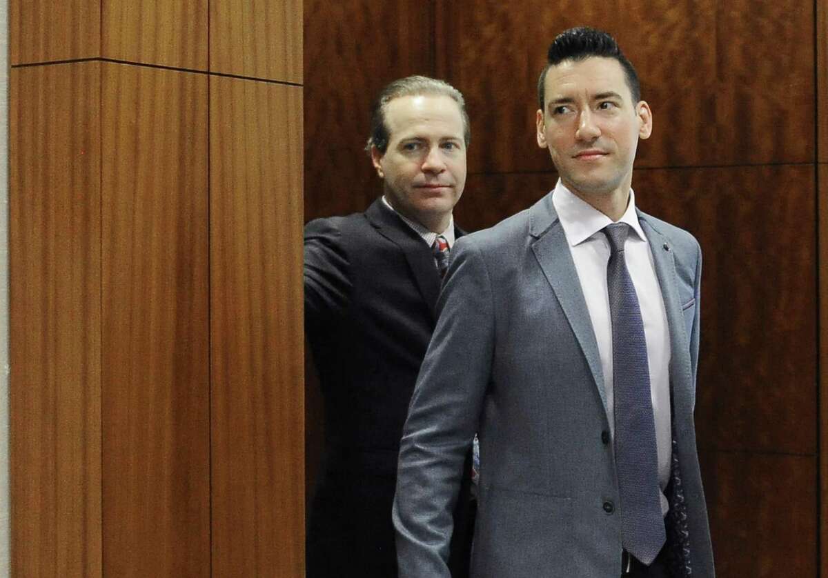 FILE - In this April 29, 2016, file photo, David Robert Daleiden, right, with attorney Jared Woodfill leave a courtroom after a hearing in Houston. A federal judge deciding whether a fellow judge should disqualify himself from a lawsuit over an anti-abortion group's videos says he could not readily discern any appearance of bias. U.S. District Court Judge James Donato said Thursday, June 22, 2017, he was having trouble understanding how Judge William Orrick's affiliation with a non-profit and two Facebook "likes" by Orrick's wife created an appearance of bias against defendant David Daleiden. (AP Photo/Pat Sullivan, File)
