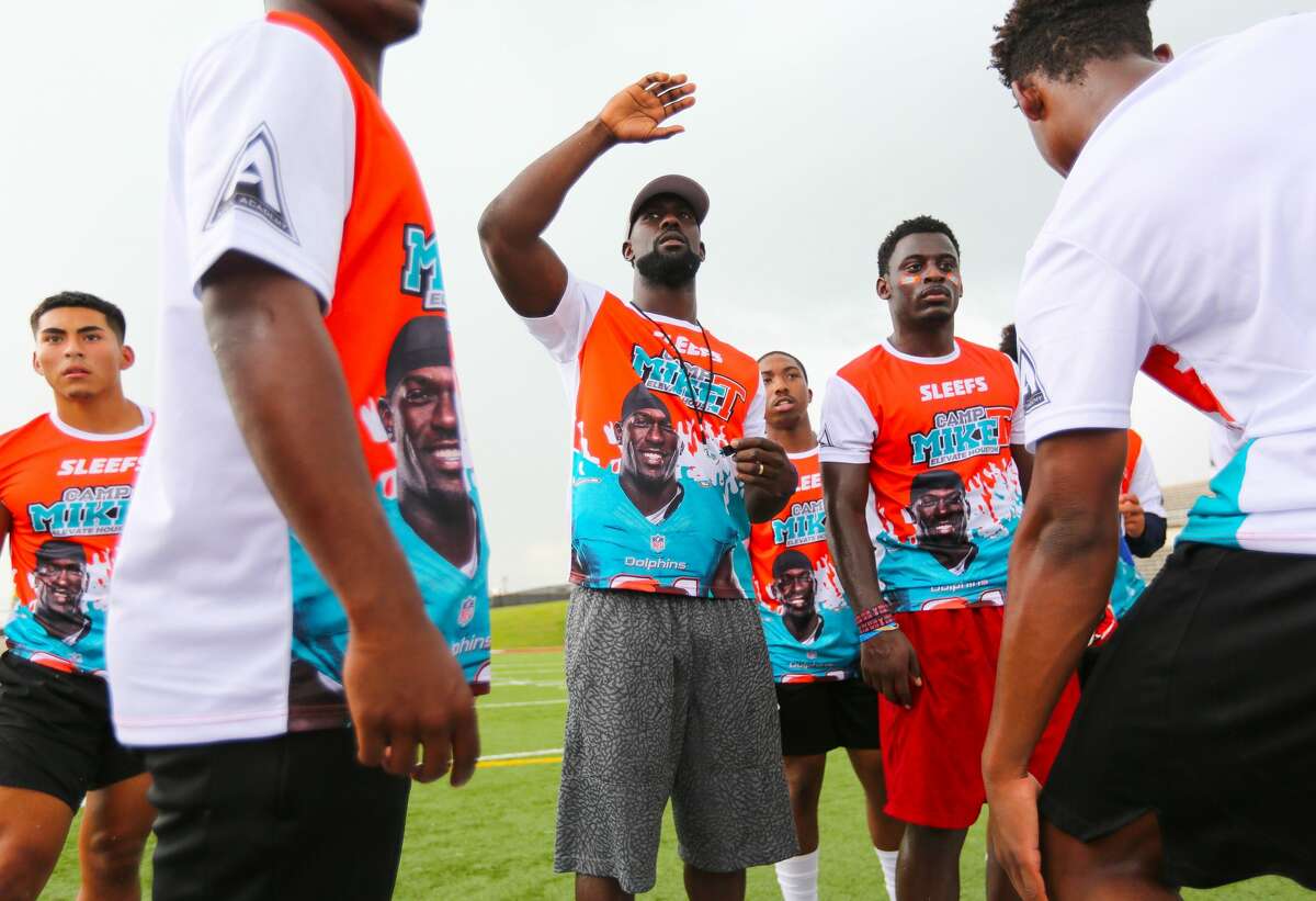 Miami Dolphins safety Michael Thomas (right), a graduate of Nimitz High School, coaches young players during his annual football camp at Aldine's Thorne Stadium, Thursday, June 29, 2017, in Houston. (Mark Mulligan / Houston Chronicle)
