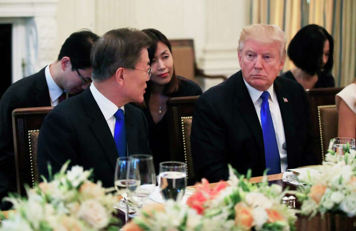 President Donald Trump listens to South Korean President Moon Jae-in, left, during a dinner in the State Dining Room of the White House in Washington, Thursday, June 29, 2017. (AP Photo/Manuel Balce Ceneta)