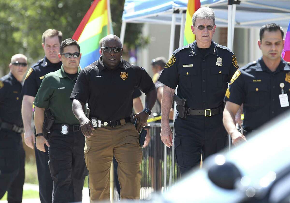 Police Chief William McManus (second from right) along with several other police officers appear near Evergreen Street and Main after police and and an unknown individual exchanged gunfire after an apparent traffic stop. (Kin Man Hui/San Antonio Express-News)