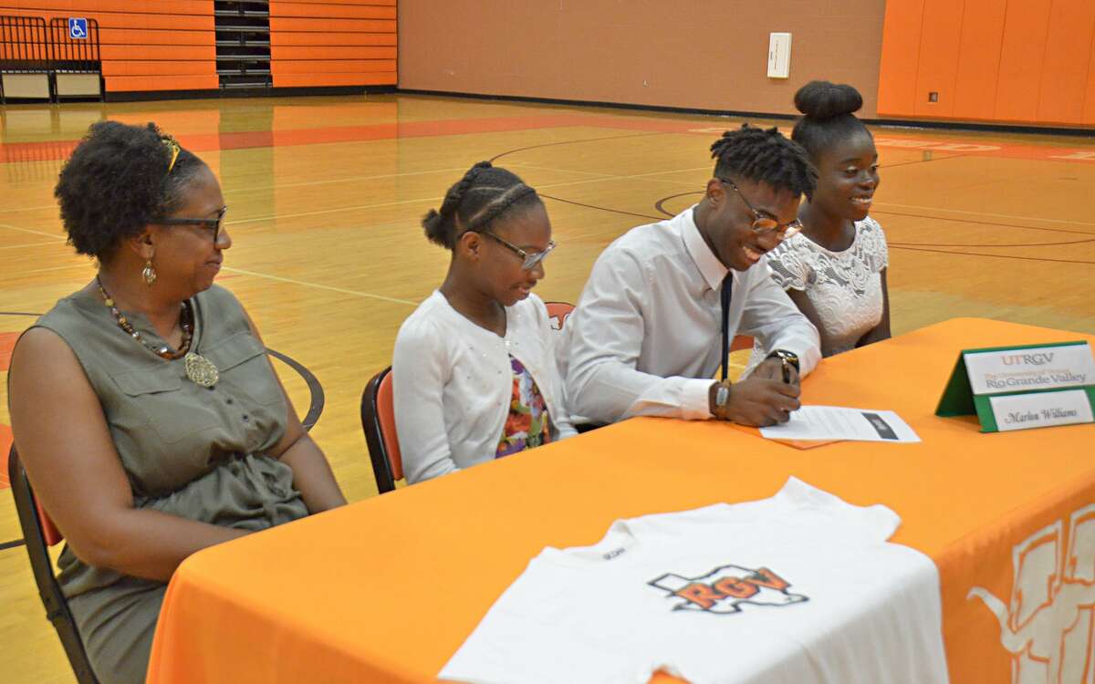 United’s Marlon Williams signed his letter of intent to play basketball at UTRGV Thursday while joined by, from left, his mother Lakeesha Williams and sisters Devan Adam and Christian Williams.