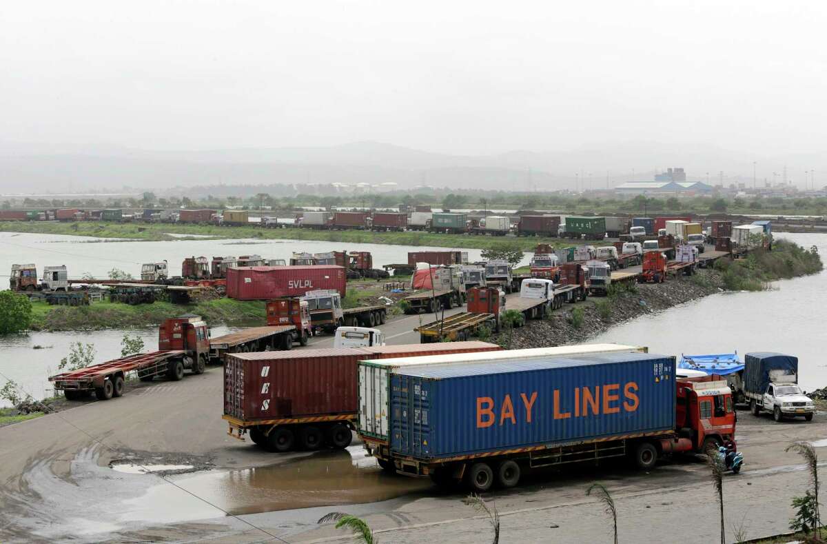 Trucks loaded with containers are lined up outside a terminal at the Jawaharlal Nehru Port Trust in Mumbai, India, Thursday, June 29, 2017. Operations at a terminal at India's busiest container port have been stalled by the malicious software that suddenly burst across the worldÂ?’s computer screens Tuesday, another example of the disruption that continues to be felt globally. (AP Photo/Rajanish Kakade)