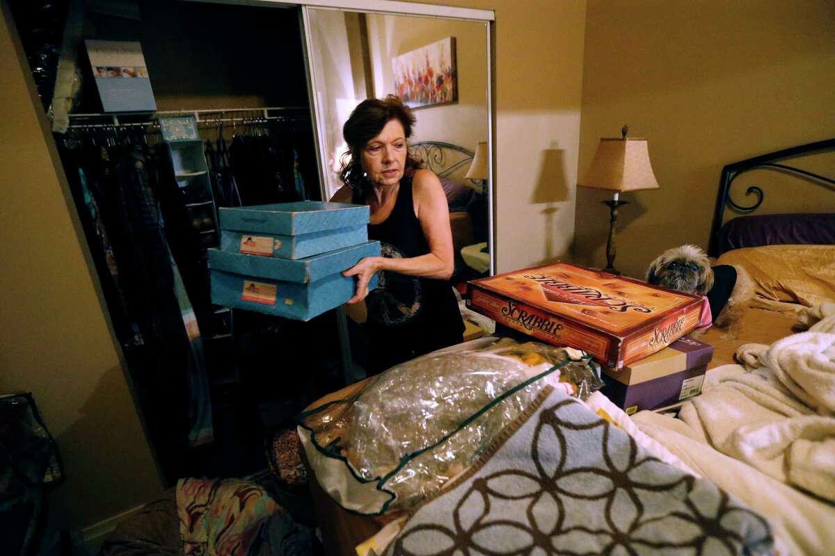 Carolyn Horton packs in preparation for her move as her affordable housing subsidies expire.