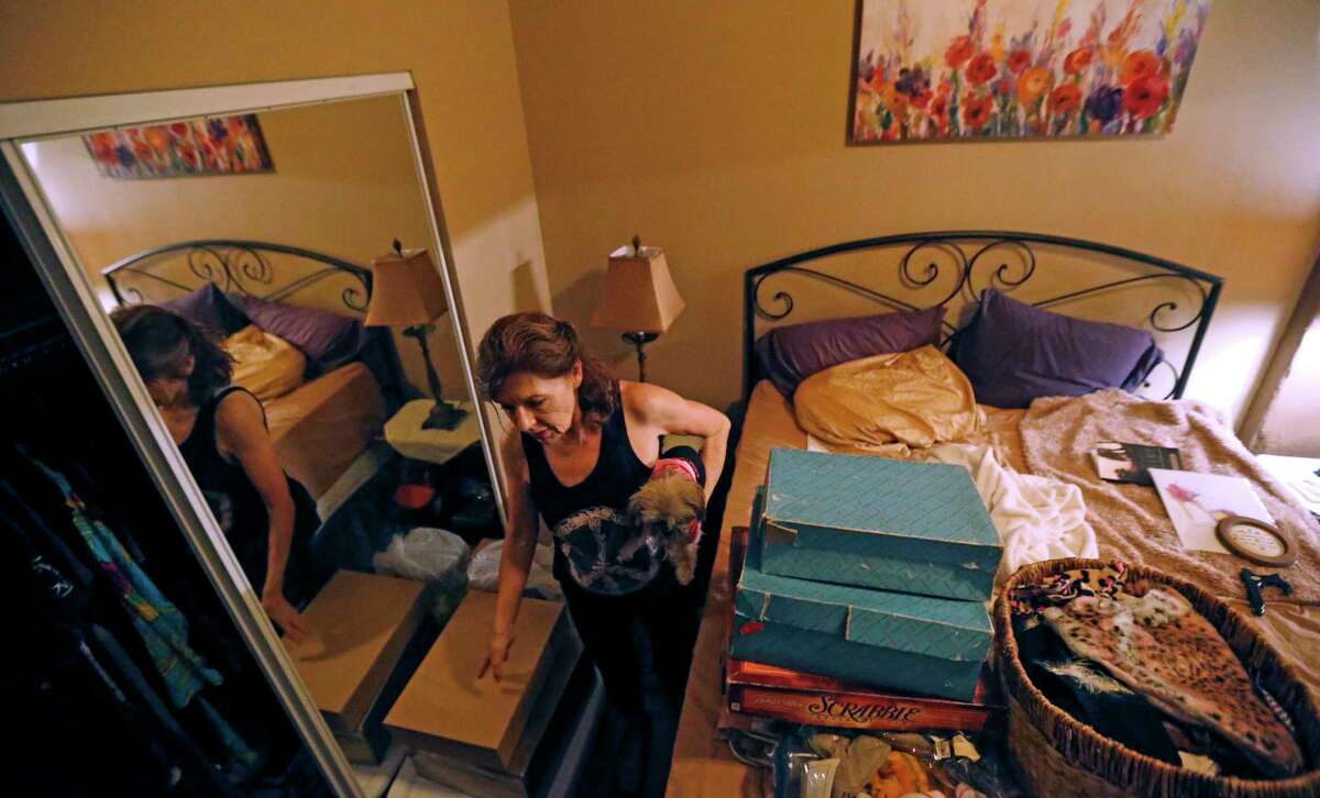 In this June 26, 2017 photo, Carolyn Horton packs her belongings in her apartment that she has to move out of as her affordable housing subsidies expire, at the American Can Apartments in New Orleans. Says Horton, "My rent was $810, but they want to raise it to $1,100 or $1,200. Now I have to income-qualify for a new place and with just under $700 in Social Security, that's not easy." (AP Photo/Gerald Herbert)