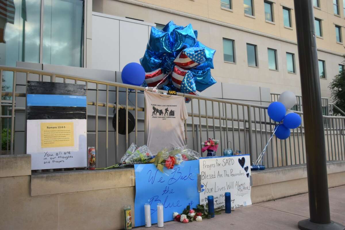 A memorial is building outside Public Safety Headquarters in downtown San Antonio after two officers were shot, one fatally, on Thursday, June 29, 2017, during a crime prevention patrol. Officer Miguel Moreno, 32, was pronounced dead at 11:11 a.m. Friday, June 30. One suspect has been killed and another suspect detained.
