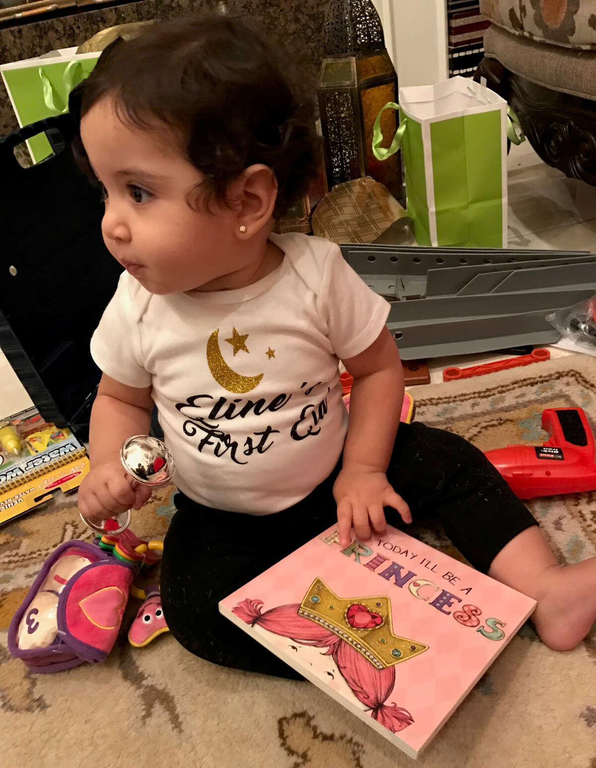 My daughter plays with her Eid gifts.