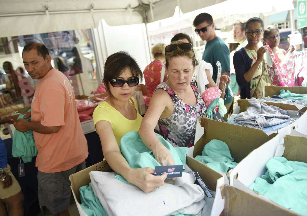 New York City resident Lana Levine, left, and Norwalk resident Debbie Barbarula browse clothes outside Vineyard Vines during the 2016 Greenwich Chamber of Commerce Sidewalk Sale Days. The sales are returning to Greenwich Avenue on July 13.