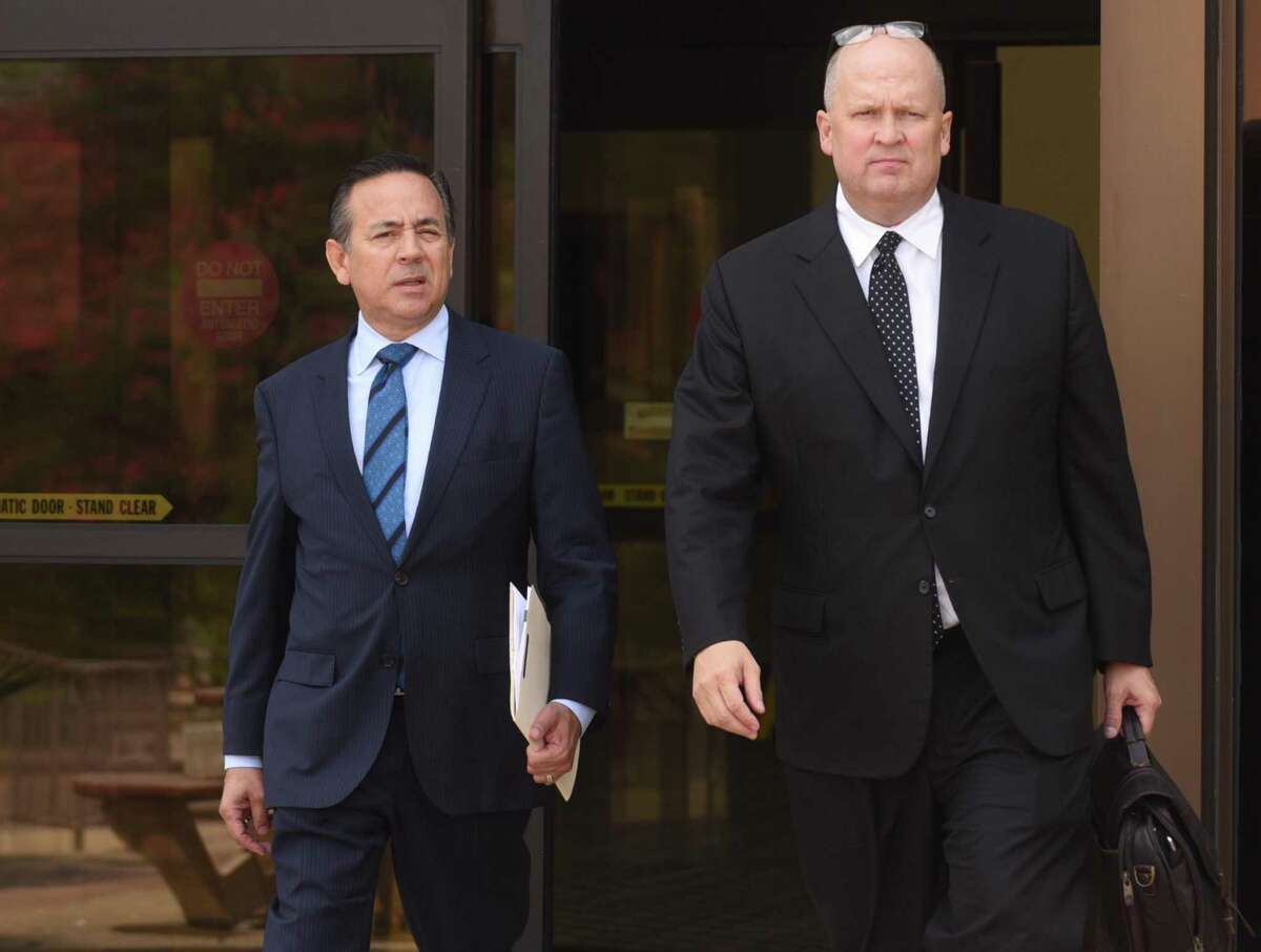 State Sen. Carlos Uresti, left, and attorney Mikal Watts leave the U.S. Federal Courthouse on Friday. Prosecutors allege Watts has a conflict of interest and are seeking to disqualify him as Uresti’s lawyer in a fraud case involving FourWinds Logistics, a defunct oil-field services company.