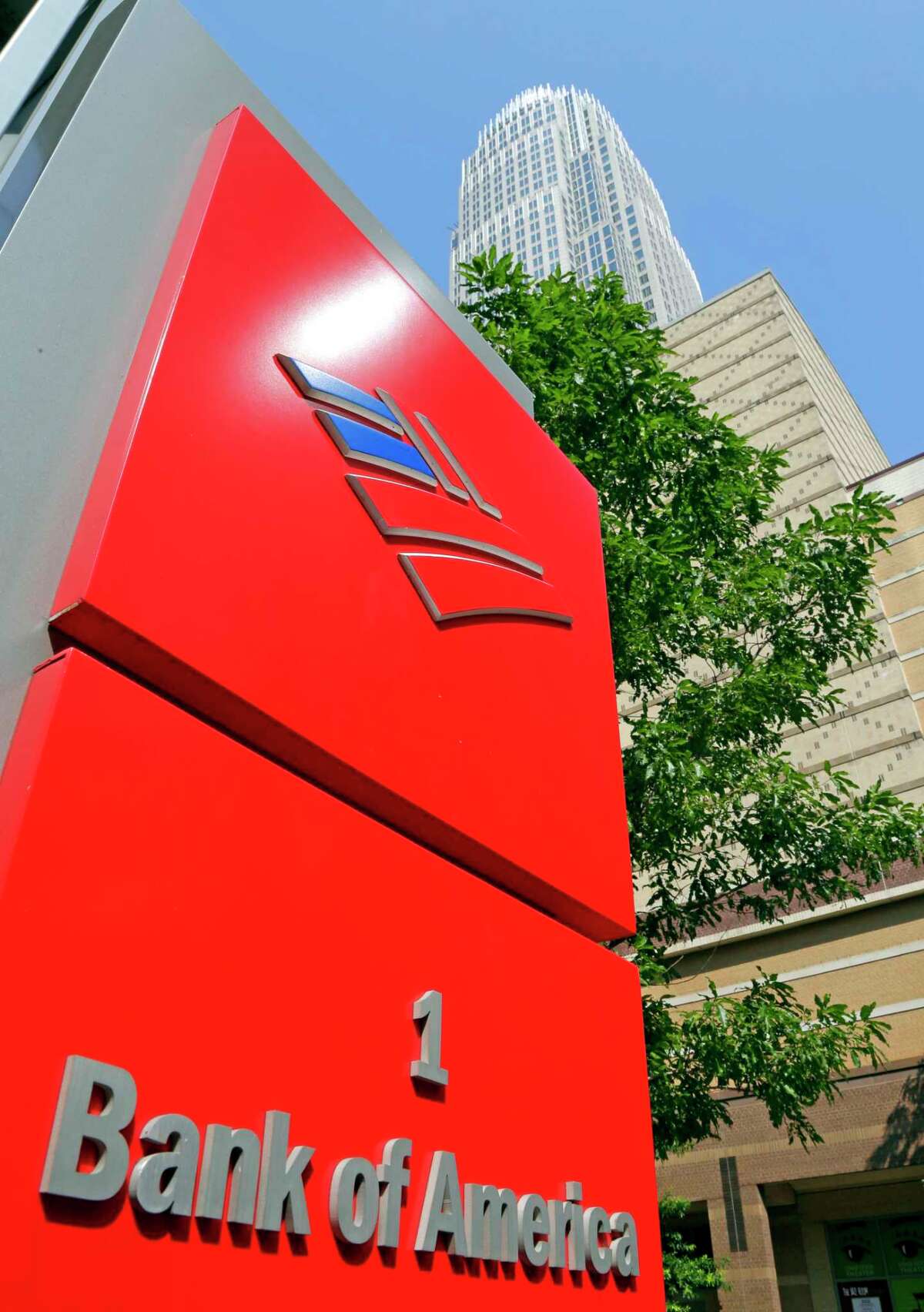 FILE - This Tuesday, July 7, 2015, file photo, shows Bank of America's corporate headquarters in Charlotte, N.C. Buffett's Berkshire Hathaway is buying 700 million shares in Bank of America, making Buffett the largest shareholder in two of the nation's largest banks. (AP Photo/Chuck Burton, File)