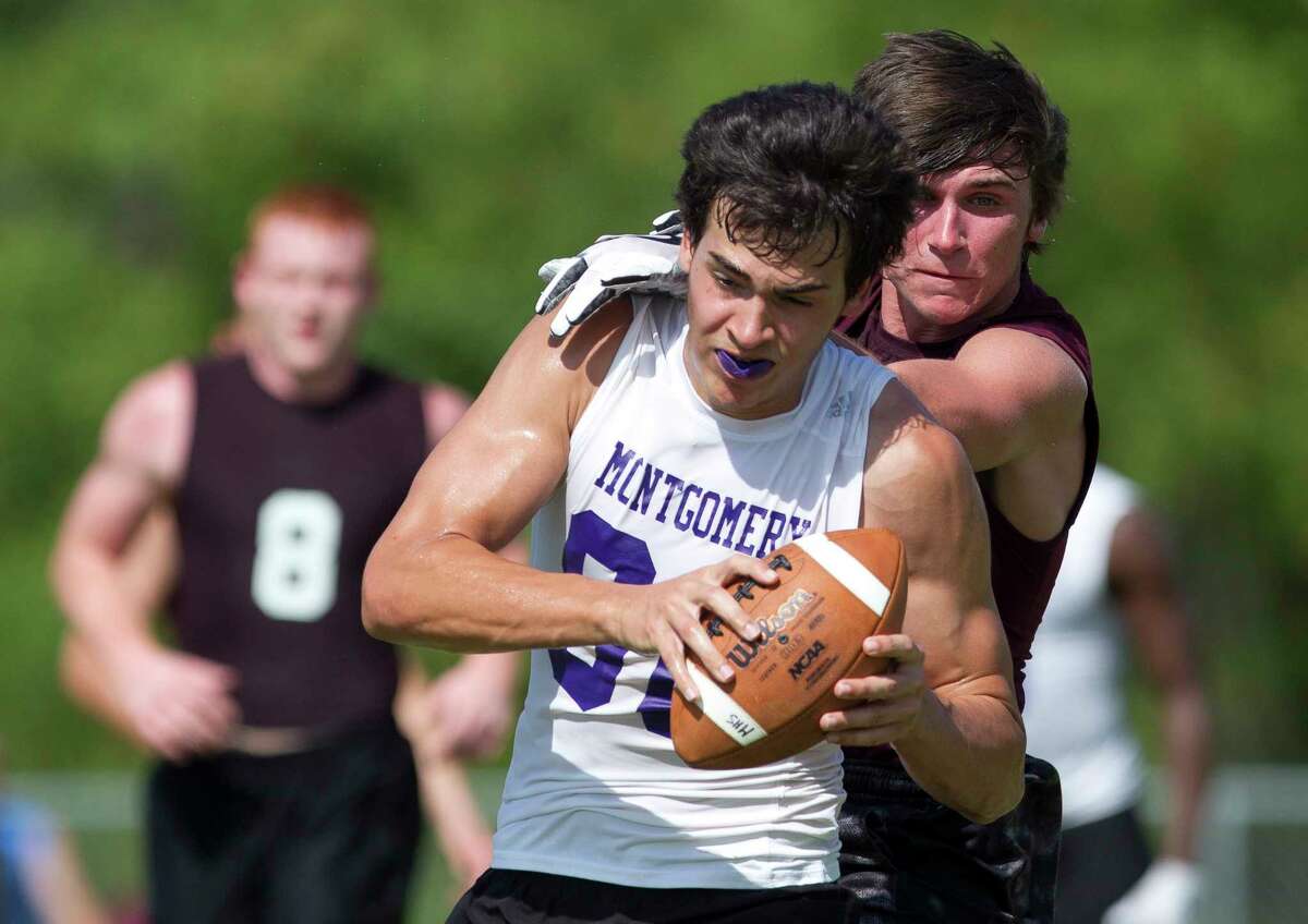 Montgomery wide receiver Jody Miller (88) catches a pass under pressure during a 7-on-7 state qualifier tournament at Porter High School, Friday, June 16, 2017, in Porter.
