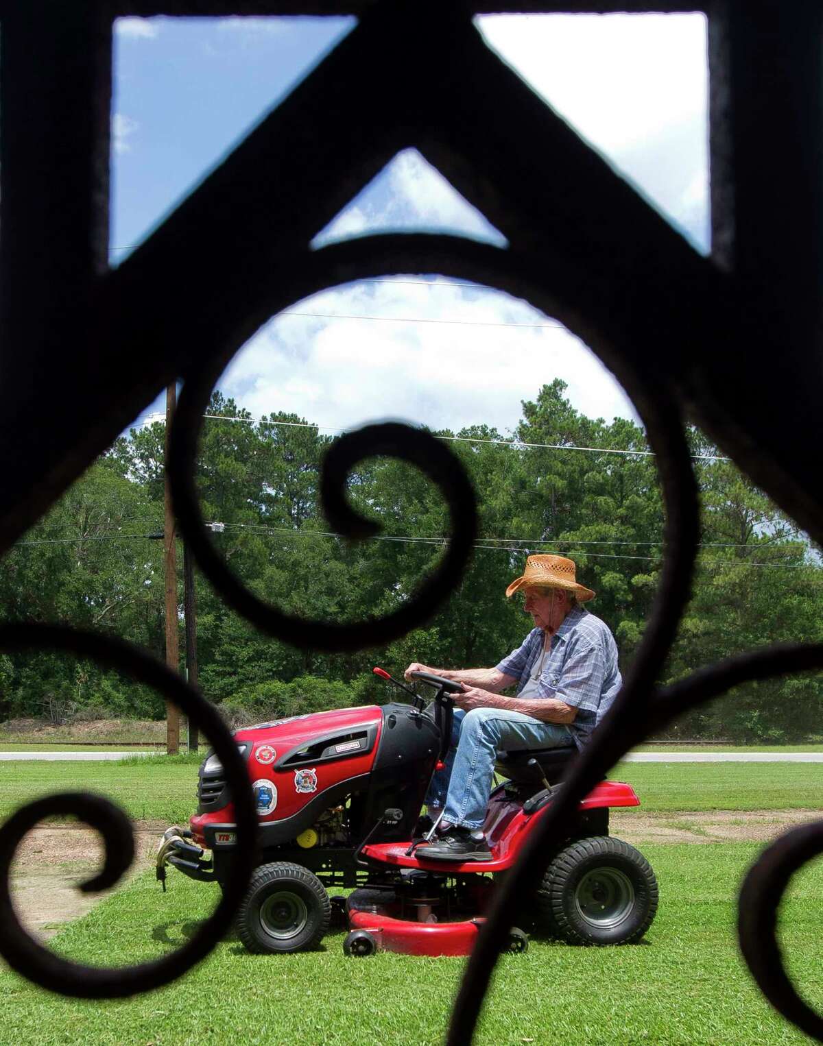 Herbert Freeman cuts the grass on his family's property on South Frazier Street, Thursday, June 29, 2017, in Conroe. The 88-year-old Korean War veteran still lives on the property that includes his childhood home his parents built in 1933. "I've been whooped twice (growing up) on this property," Freeman said laughing as he wiped sweat off his face. "I guess I still am."