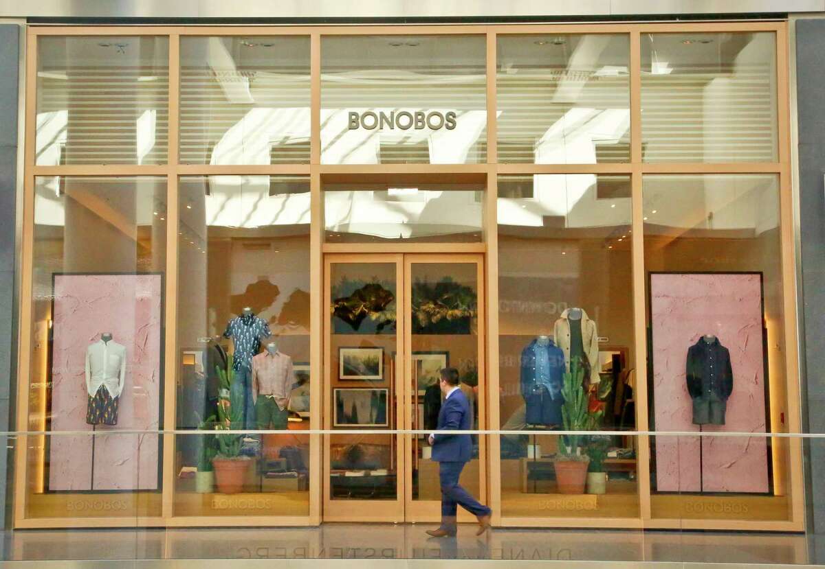 FILE - In this Monday, March 20, 2017, file photo, a man walks by the Bonobos Guideshop in New York's Financial District. Some shoppers are fretting about having big companies take over their favorite brands. WalmartÂ?’s recent purchase of clothing labels ModCloth and Bonobos, which cater to upper-income millennials, have shoppers anxious that it will cheapen the quality of the clothes, with some customers pledging on social media never to shop there again. (AP Photo/Bebeto Matthews, File)