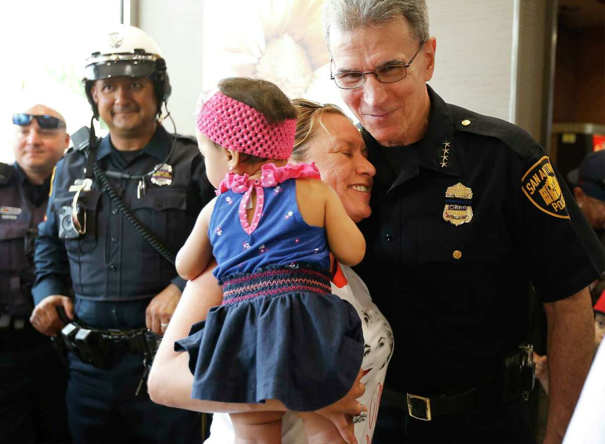 Sylvia Ornelaz with her 10-month-old granddaughter Demi Rae Garcia offers a hug to San Antonio Police Department Chief William McManus as he along with other SAPD officers and members of the San Antonio Fire Department attend a "Coffee with Cops" event at McDonald's on Roosevelt Avenue on the city's Southside on Saturday, July 1, 2017.