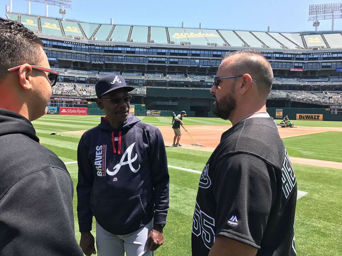 Former A's catcher Ramon Hernandez, right, and his son, Randy, left, chat with Braves coach Ron Washington