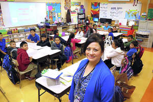 Bruni Elementary 5th grade teacher Patricia Rodriguez poses with her students Monday morning as they start the new school year.